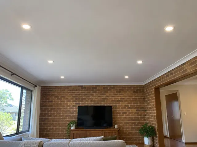 Ceiling downlights in a brick-walled living room with TV and window in Morisset